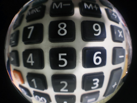 Sphere of button calculator with dim light, focus on number 5.の写真素材