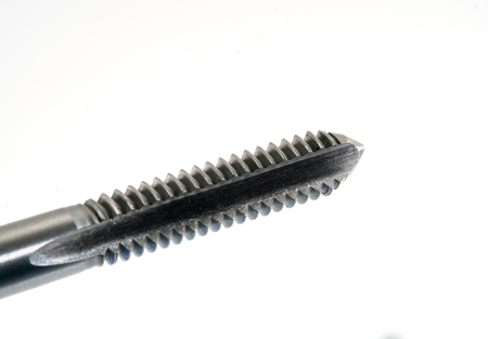 Hand tap (threading tool) on white background.の写真素材