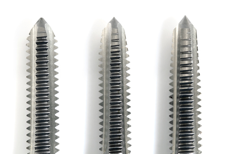 Hand tap (threading tool) on white background.の写真素材