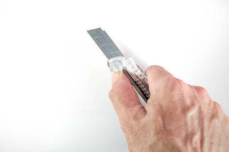 Paper knife in hand on white background.の写真素材