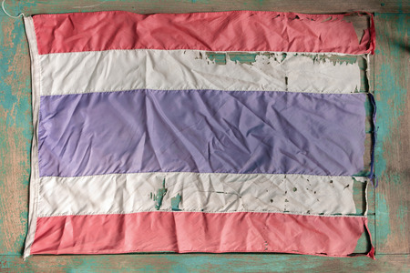 Old Thai flag on old wood background. Top view. Flat lay.