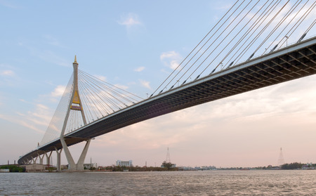 View of elevated expressway cross the river at twilight.の写真素材