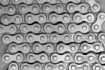 Abstract background texture of old and dirty roller chain for motorcycle. Top view.の写真素材