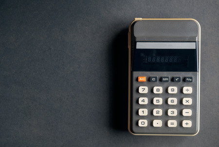View of calculator on dirty black paper background.の写真素材