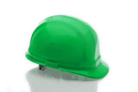 Green safety hat on the table.の写真素材