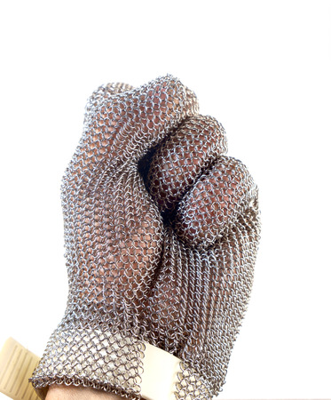 Hand with iron mesh glove on white background. Protection devices for industrial applications.の写真素材
