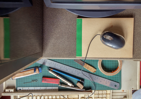 View of desk with computer and stationery. Top view.