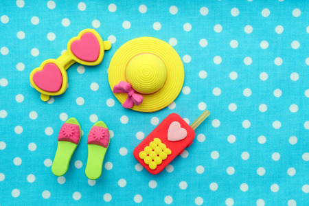 View of miniature toy fashion on blue cotton. Top view. Flat lay.