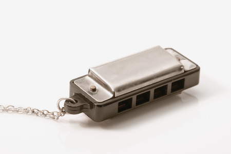 Toy harmonica on white background. Vintage style.の写真素材