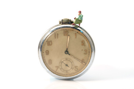 View of miniature toy worker on vintage clock.の写真素材