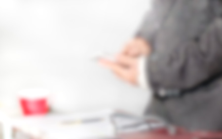 Blur of business man holding smartphone in the office.の写真素材