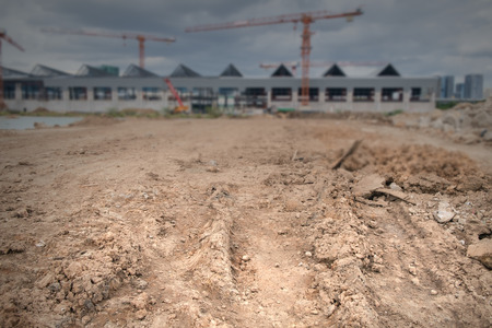 View of ground with blur construction site background. Dark tone.の写真素材