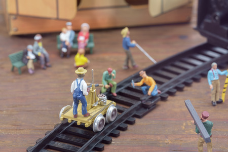 View of construction site of mini toy worker on wood background.の写真素材