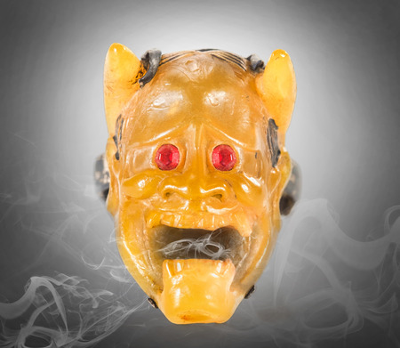 Plastic devil ring with smoke. Dark tone.