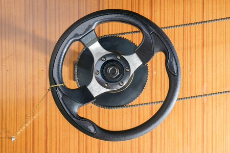 Steering wheel on wood wall.の写真素材