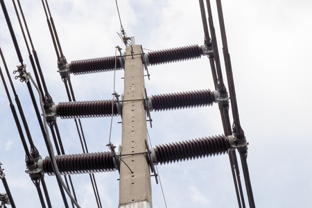 View of electricity pole on blue sky background.