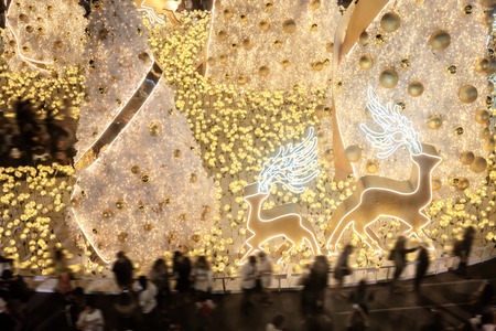 View of decoration on christmas tree with people at night. Soft focus.の写真素材