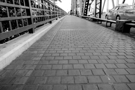 View of pathway paved with stone block on the bridge. Shallow depth of field. Black and white tone.の写真素材