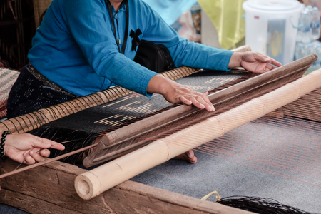 View of woman weaving on loom.の写真素材