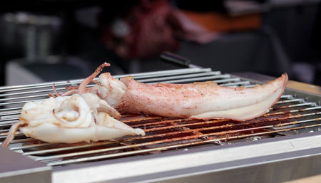 View of grilled squid on stove in the market. Street food.の写真素材