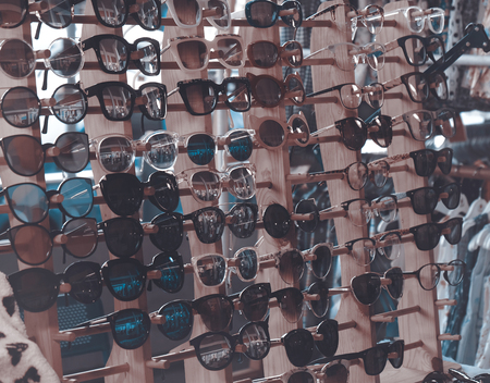 Sunglasses on shelf in the store. Shallow depth of field.の写真素材