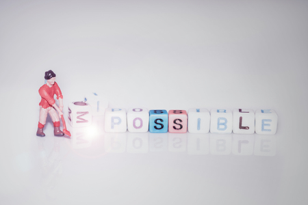 Possible. Motivational quote for life of alphabet cube on white background with miniature toy of worker.の写真素材