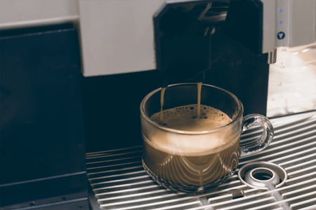 View of cup of coffee on coffee machine. Vintage style.の写真素材