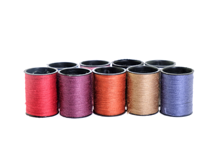 View of thread spool on white background.