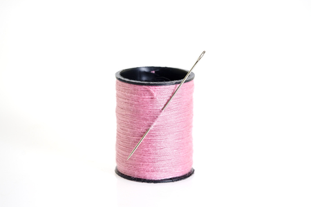 View of thread spool with needle on white background.の写真素材