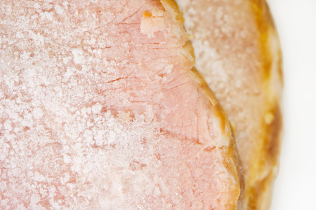 Close up of frozen pork on white background.の写真素材