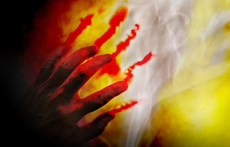 Human hand with blood on dark background.の写真素材
