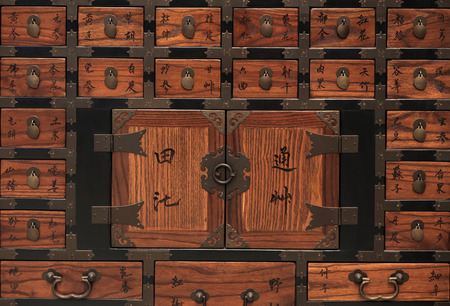 Close up of old wooden medicine cabinet on white background. Soft focus. Text mean : name of herbal.の写真素材