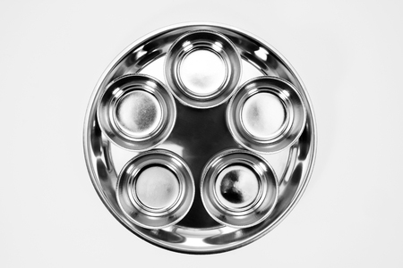 Stainless cups on stainless tray on white background. Top view.の写真素材