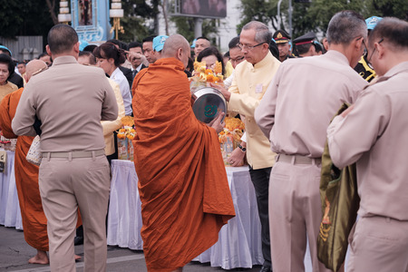 BANGKOK, THAILAND - DECEMBER 05: View of people give alms to Buddhist monk. Traditions of Merit, Father's Day, Royal palace of Ananta Samakhom on December 05,2017 in Bangkok, Thailand.のeditorial素材