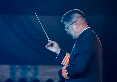 BANGKOK, THAILAND - DECEMBER 23: View of conductor in concert at night. Movement, Soft focus, Royal palace of Ananta Samakhom on December 23,2017 in Bangkok, Thailand.のeditorial素材