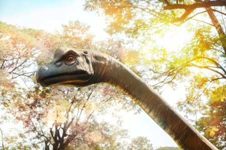 View of dinosaur statue on nature background.