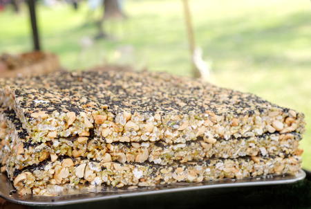 View of Krayasart, Thai dessert on stainless tray. Made of rice, nut, sesame-seeds and sugar. Shallow depth of field.の写真素材