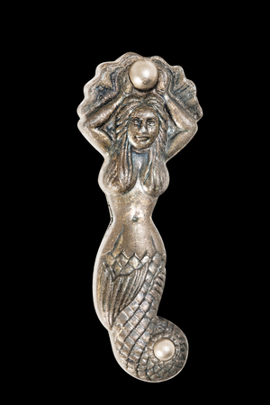 Mermaid on black background, made from brass.の写真素材