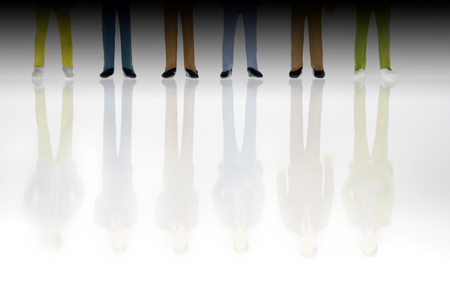 Reflexion of toy businessman on white background.