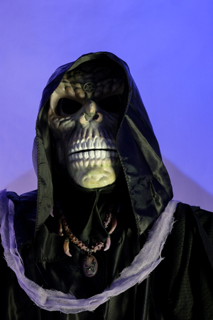 Hooded skeleton on blue background. Grim Reaper, The Death.の写真素材