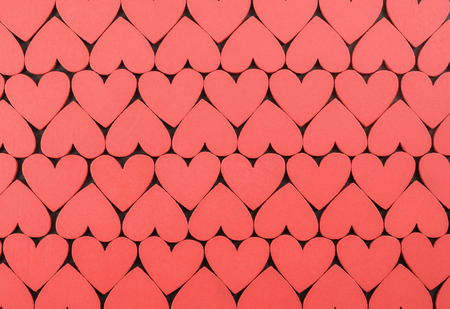 Red hearts on black background.の写真素材