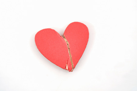 Broken red heart on white background.