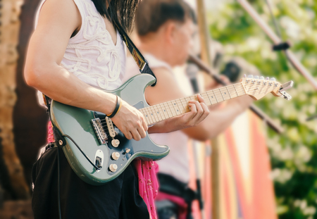 View of musician playing the guitar in concert. Movement.の写真素材