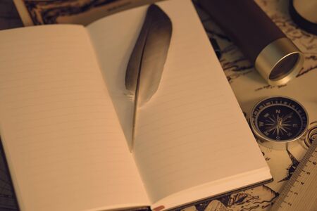 View of feather on the book. Retro style. Soft focus.の写真素材