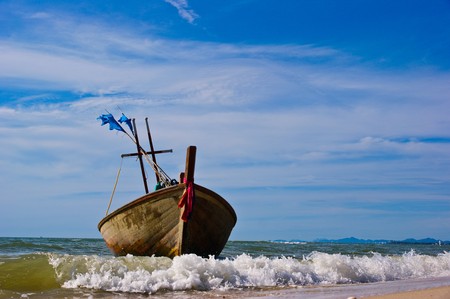 Fishing boat at cha-am beach in Thailandの写真素材