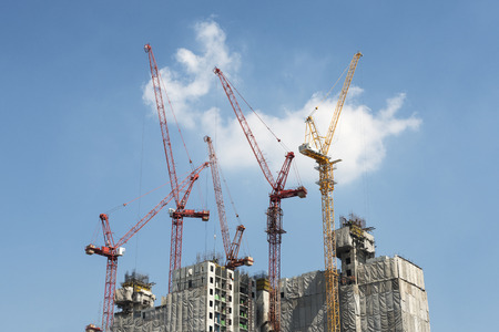 Group of construction crane on workplace against blue sky background