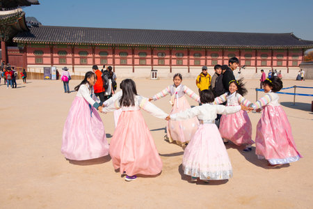 Seoul, South Korea, November 2018.Young Korean Girls dressed Hanbok in traditional dress are playing at Gyeongbokgung Palace Seoul, South Koreaのeditorial素材