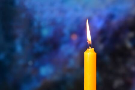 candle burning brightly with bokeh backgroundの写真素材