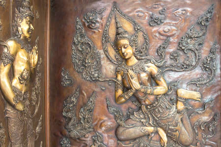 Buddha metal copper carving on temple wall in Thailand.Buddha sculpture tell the story about the...
