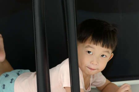 Little boy crawling under the chair.Playful time